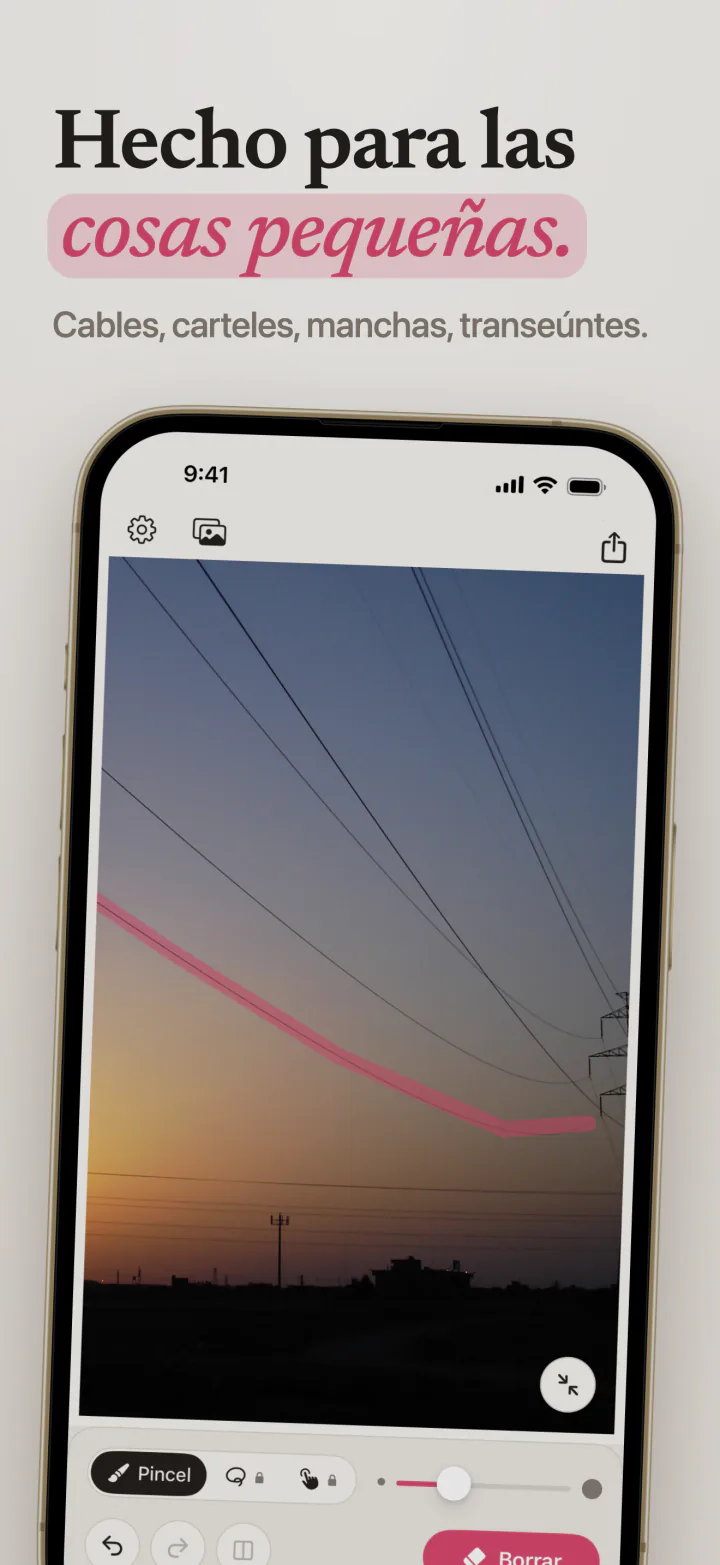 Mend en iPhone con un trazo rosa a lo largo de un cable eléctrico que cruza el cielo del atardecer
