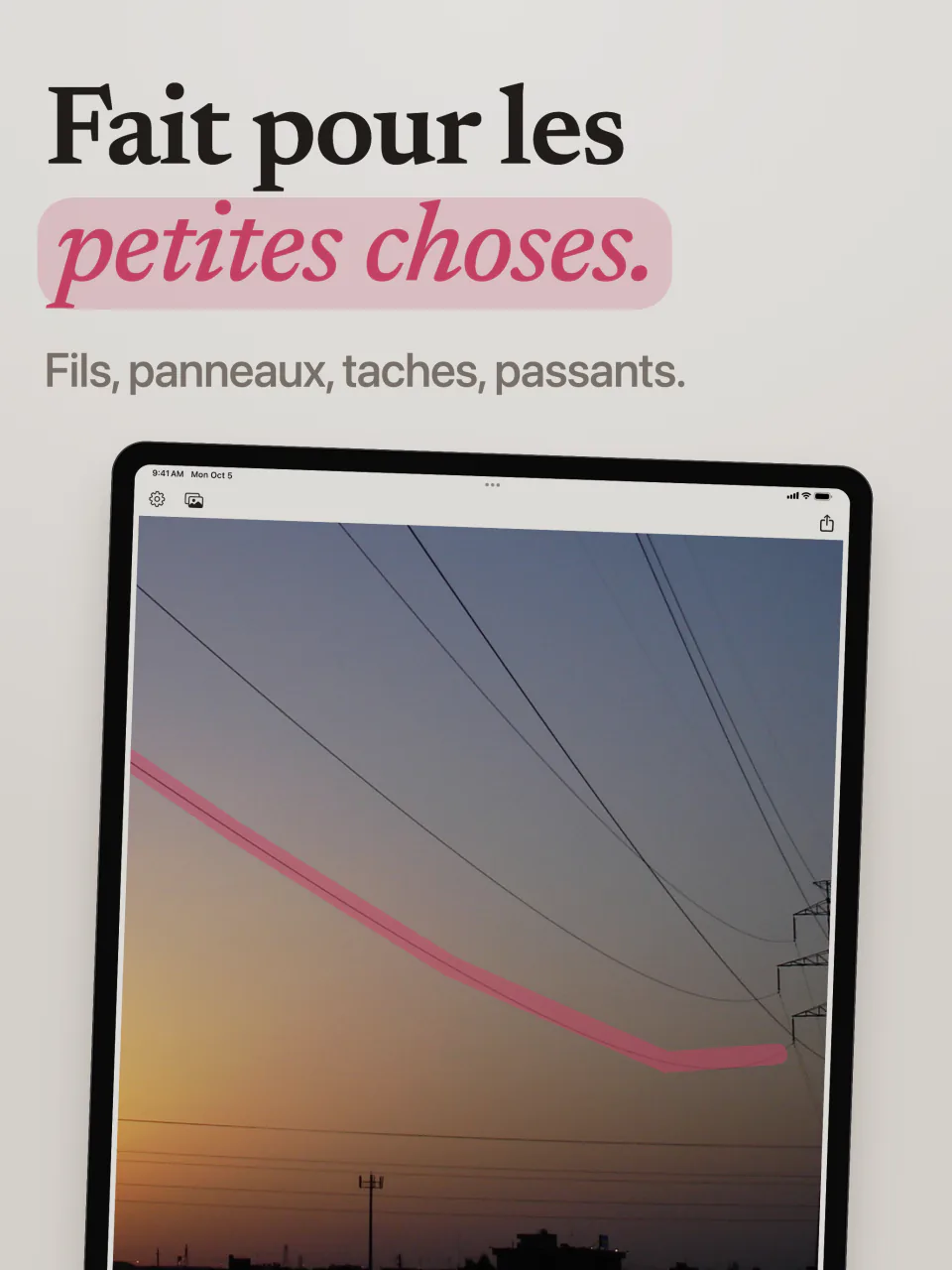 Mend sur iPad avec un trait rose le long d’une ligne électrique qui traverse le ciel du soir